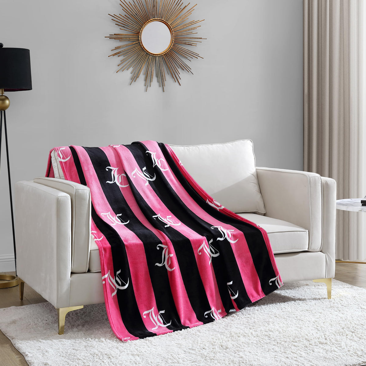 Juicy Couture Cabana Plush throw on sofa with hot pink striped design