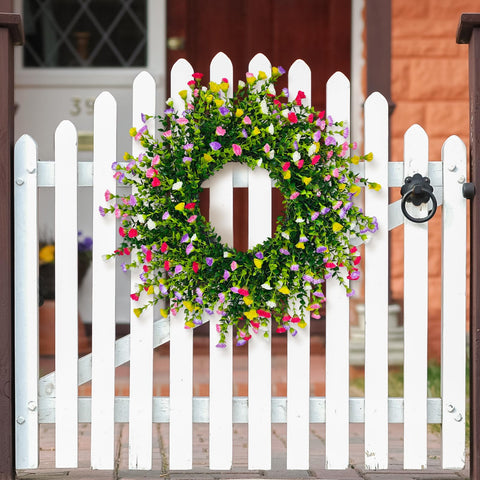 Julako wreath showing pink, purple, yellow, and white carnations creates cheerful seasonal decor