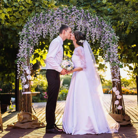 JUSTOYOU Wisteria garland wrapped around railing adds romantic ambiance.