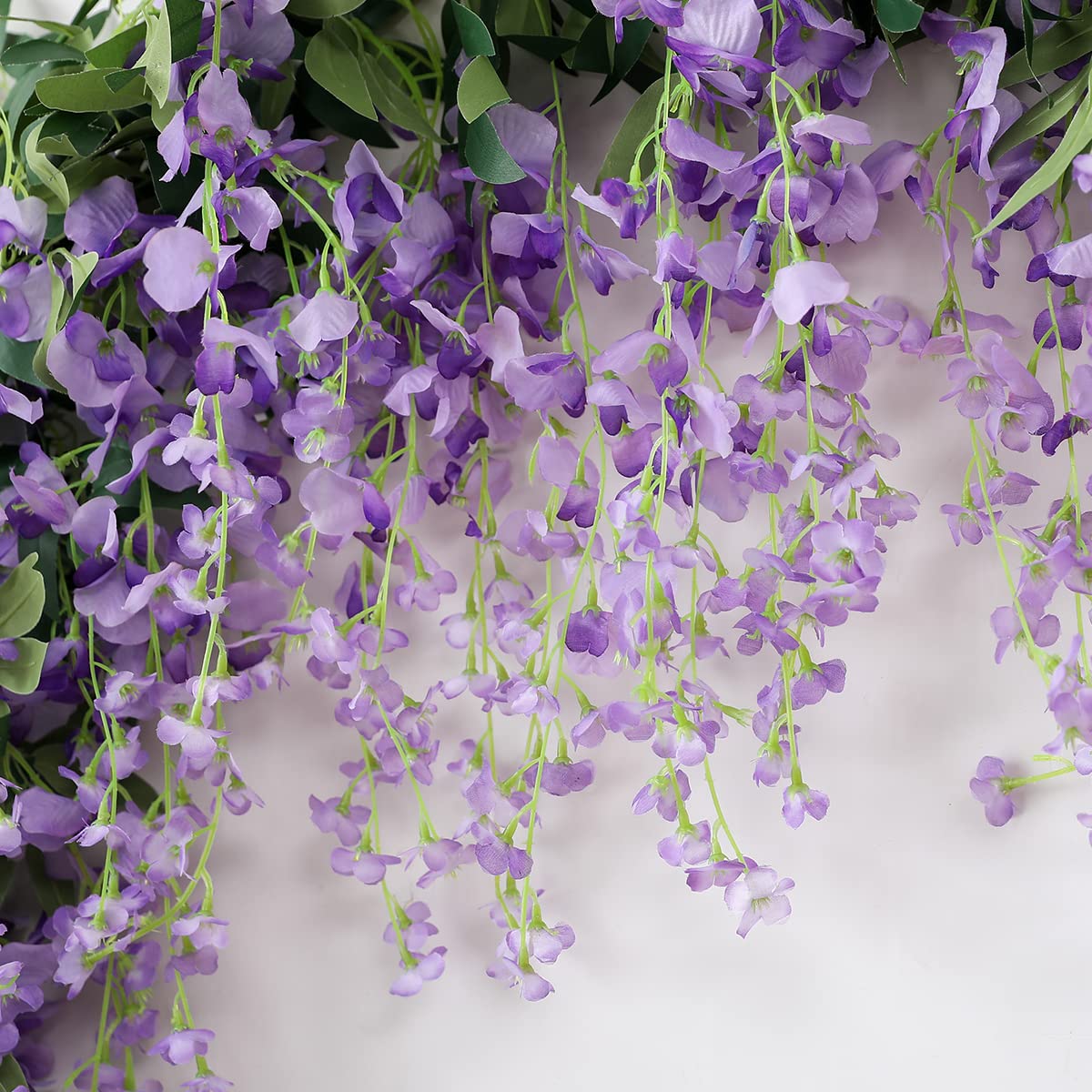 JUSTOYOU Wisteria garland with bendable stems for easy shaping.