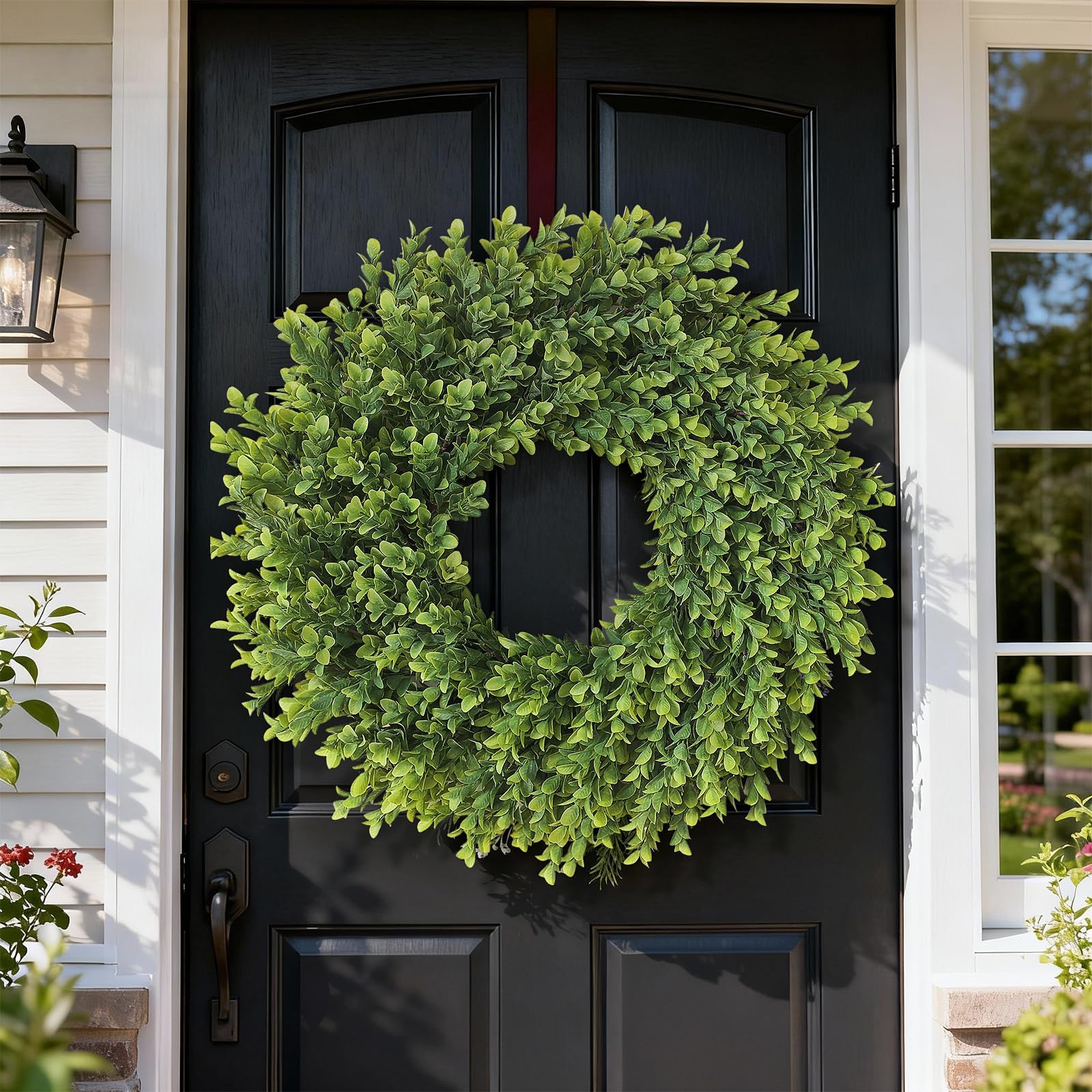 Juxdp boxwood wreath close-up shows lifelike texture and faux twigs.