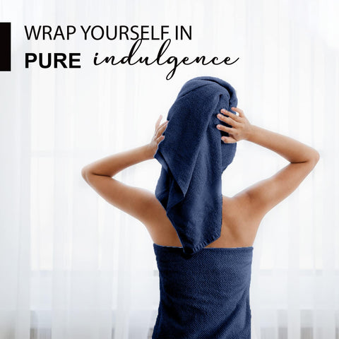 KAHAF COLLECTION navy towel folded stack demonstrates generous 24x48 size for home or gym.