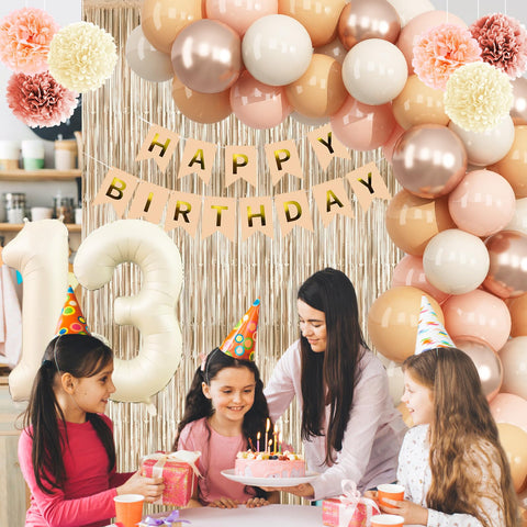 KAINSY blush paper pom poms brighten corners and photo spots.