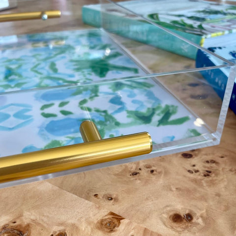 Katie Romeo Designs watercolor botanical greens and blues on a clear tray adds vibrant art.