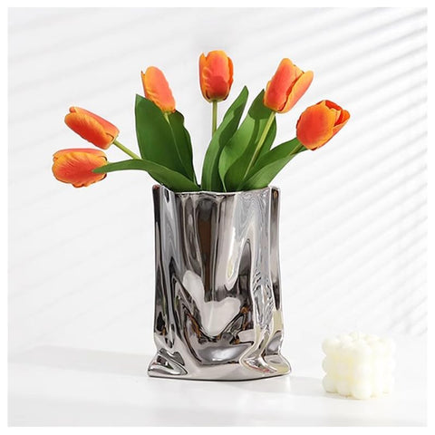 Katoonx silver metal vase on a mantel adds subtle shine to living spaces.