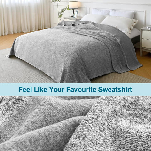 KAWAHOME Sweatshirt Blanket draped on sofa for TV night comfort