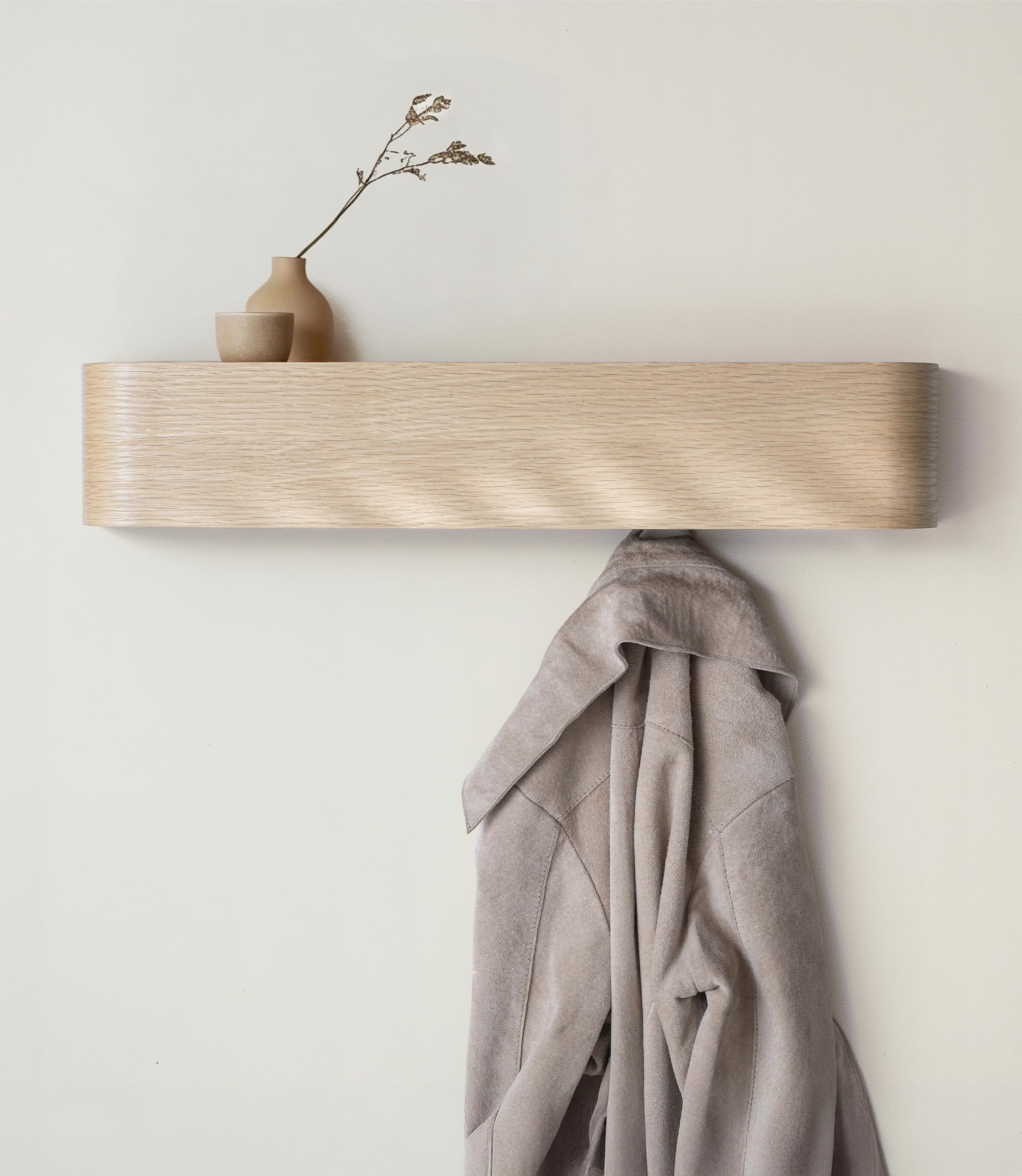 Kazai Toke wall-mounted coat rack with hidden hooks in a modern entryway.