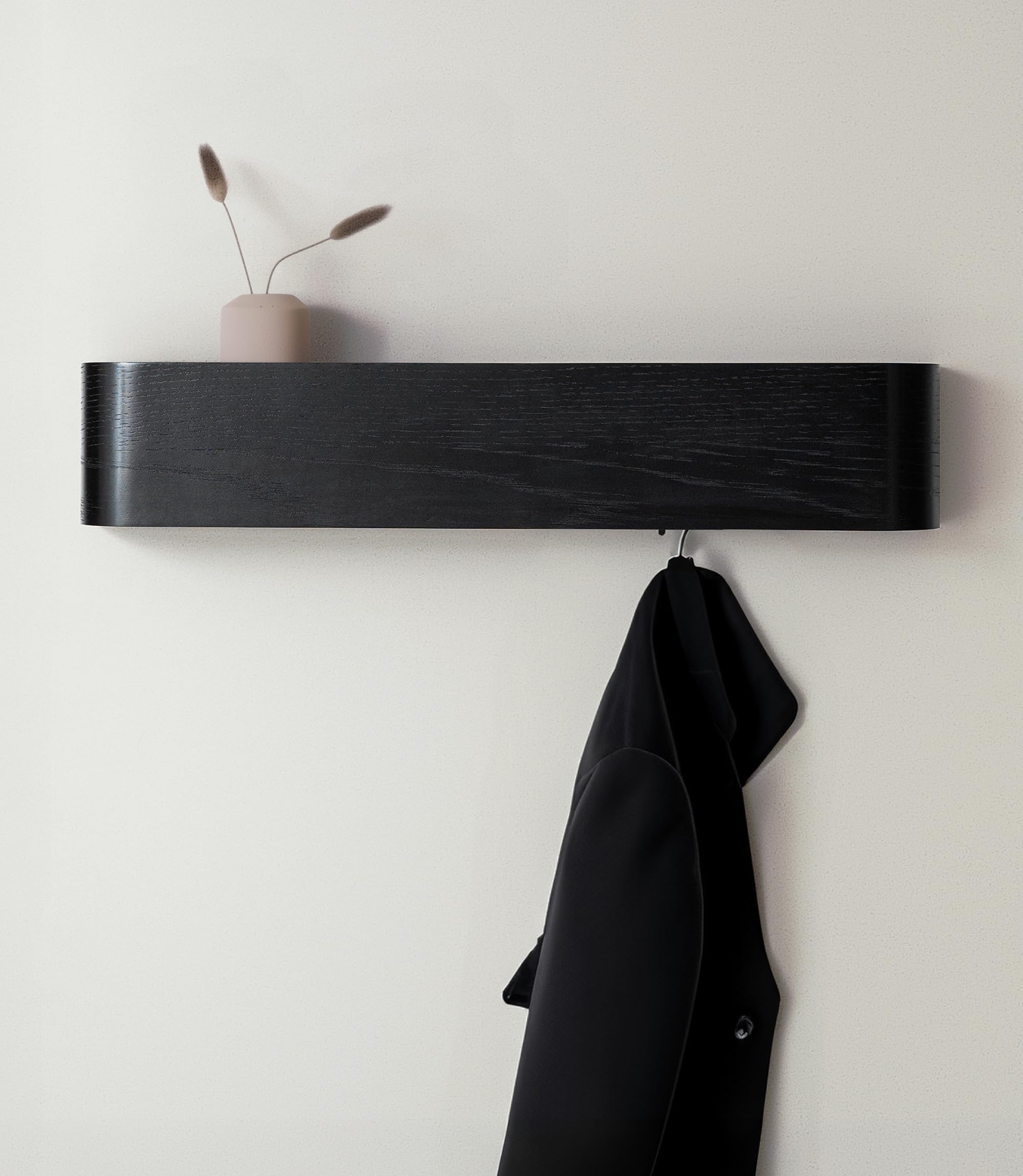 Kazai Toke wall-mounted coat rack with hidden hooks keeps entryway clutter-free.