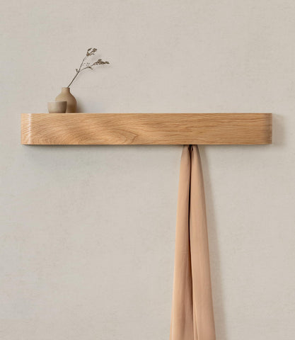 Kazai Toke wall-mounted coat rack with hidden hooks keeps coats and bags organized.