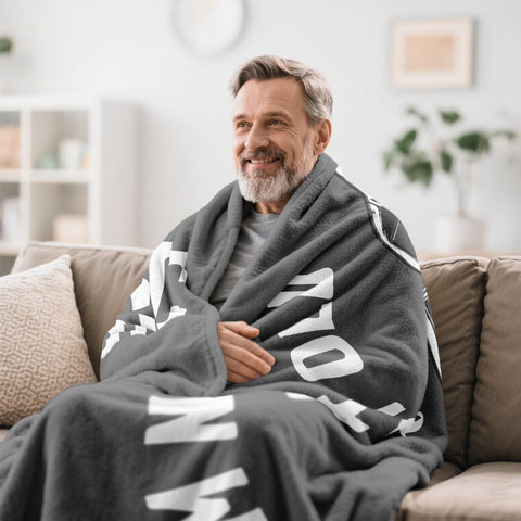 Kazdan 50x60 inch blanket shown on a couch for cozy lounging.