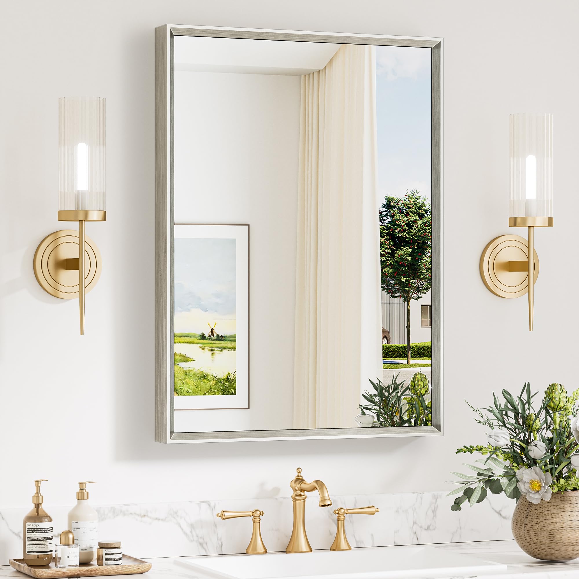 Keonjinn brushed nickel mirror over sink with beveled edge for daily grooming.