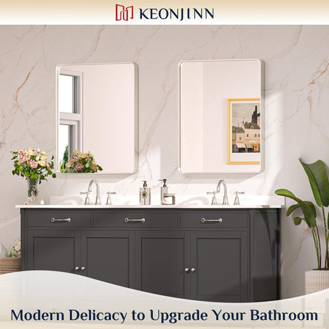 Keonjinn rounded rectangle mirror with brushed gold finish adds warmth and moisture resistance