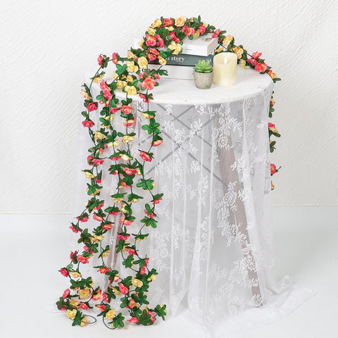 Khoyime rose garland decorating dining table for festive dinner settings.