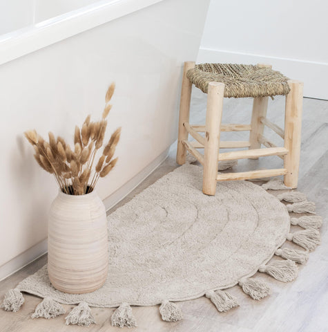 KIBAGA beige half-moon rug creates a stylish focal point in bath or bedroom