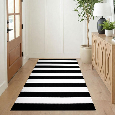 KILOCOCO striped outdoor rug for porch that withstands weather and resists stains.