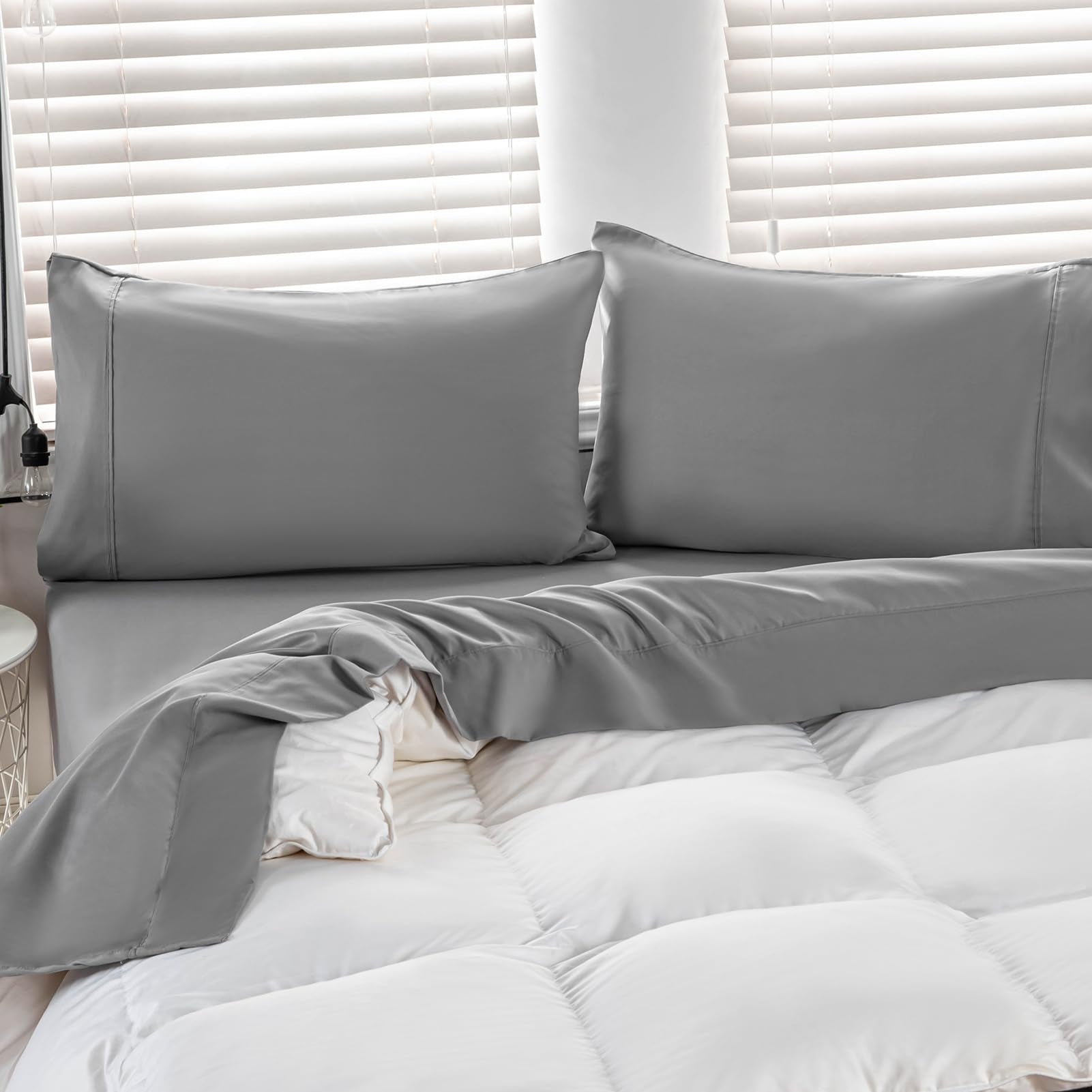 Kingnex bed setup with oversized flat sheet draping over a large bed
