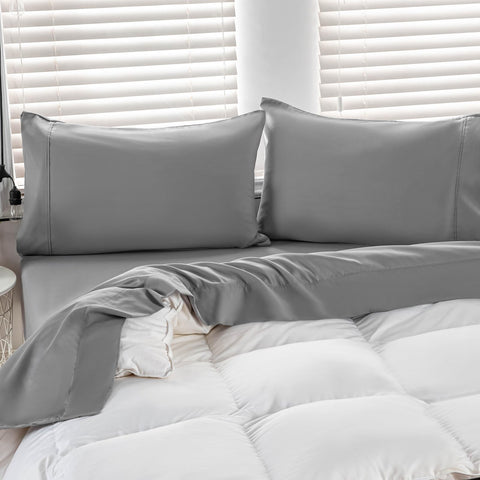 Kingnex bed setup with oversized flat sheet draping over a large bed