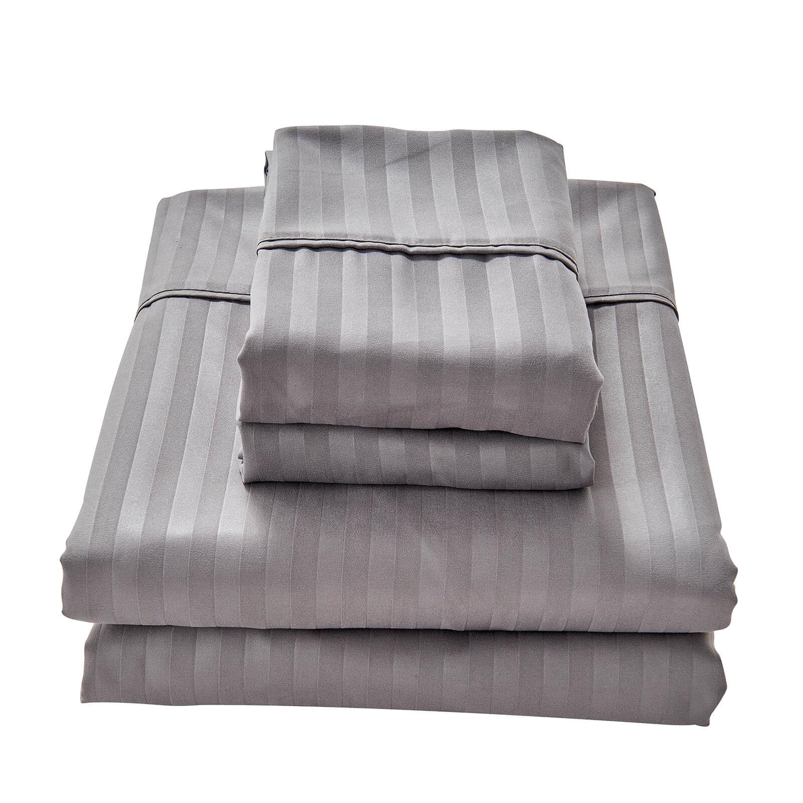Kingnex flat sheet draped over a queen sleeper sofa for full coverage