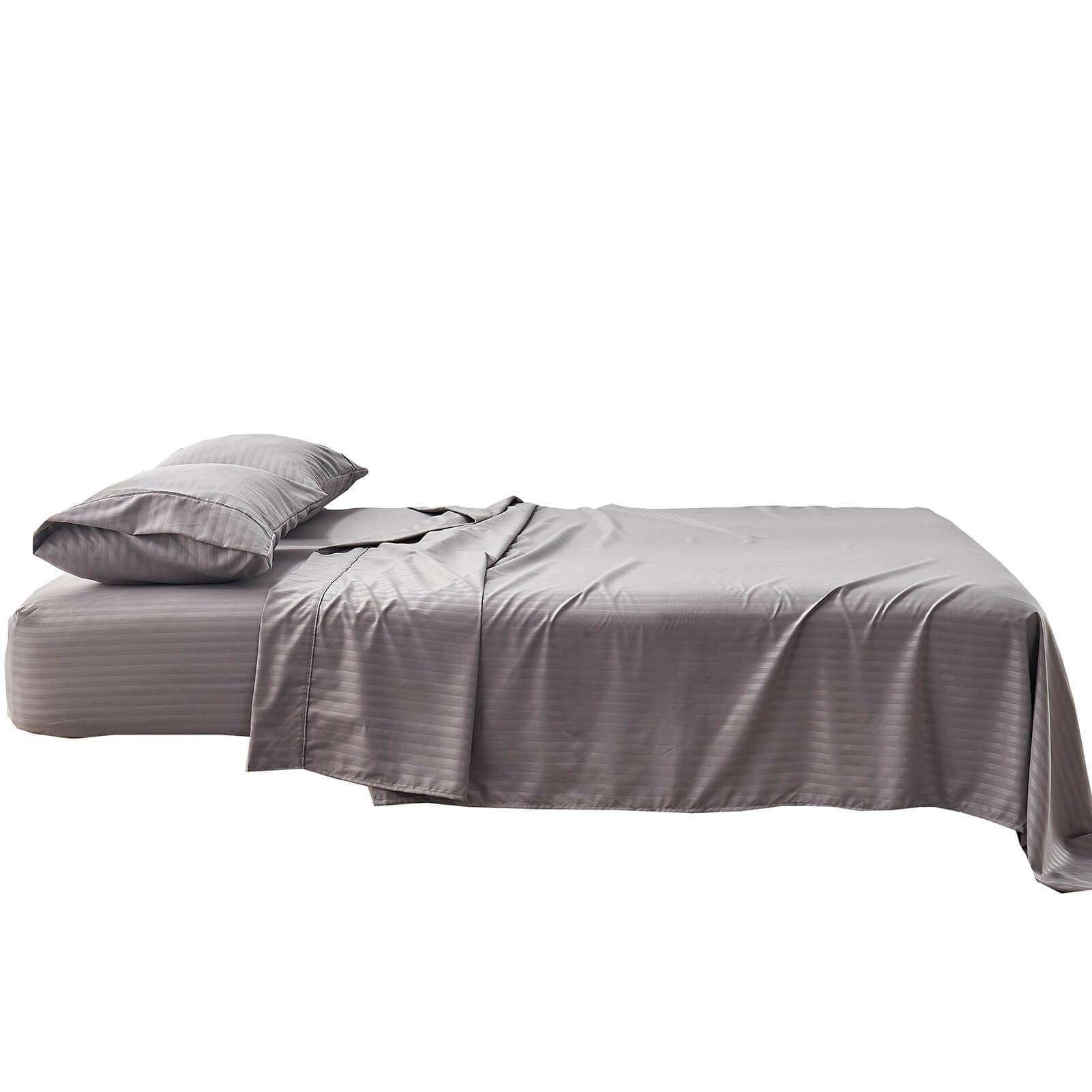 Kingnex striped sheets arranged on a sleeper sofa setup
