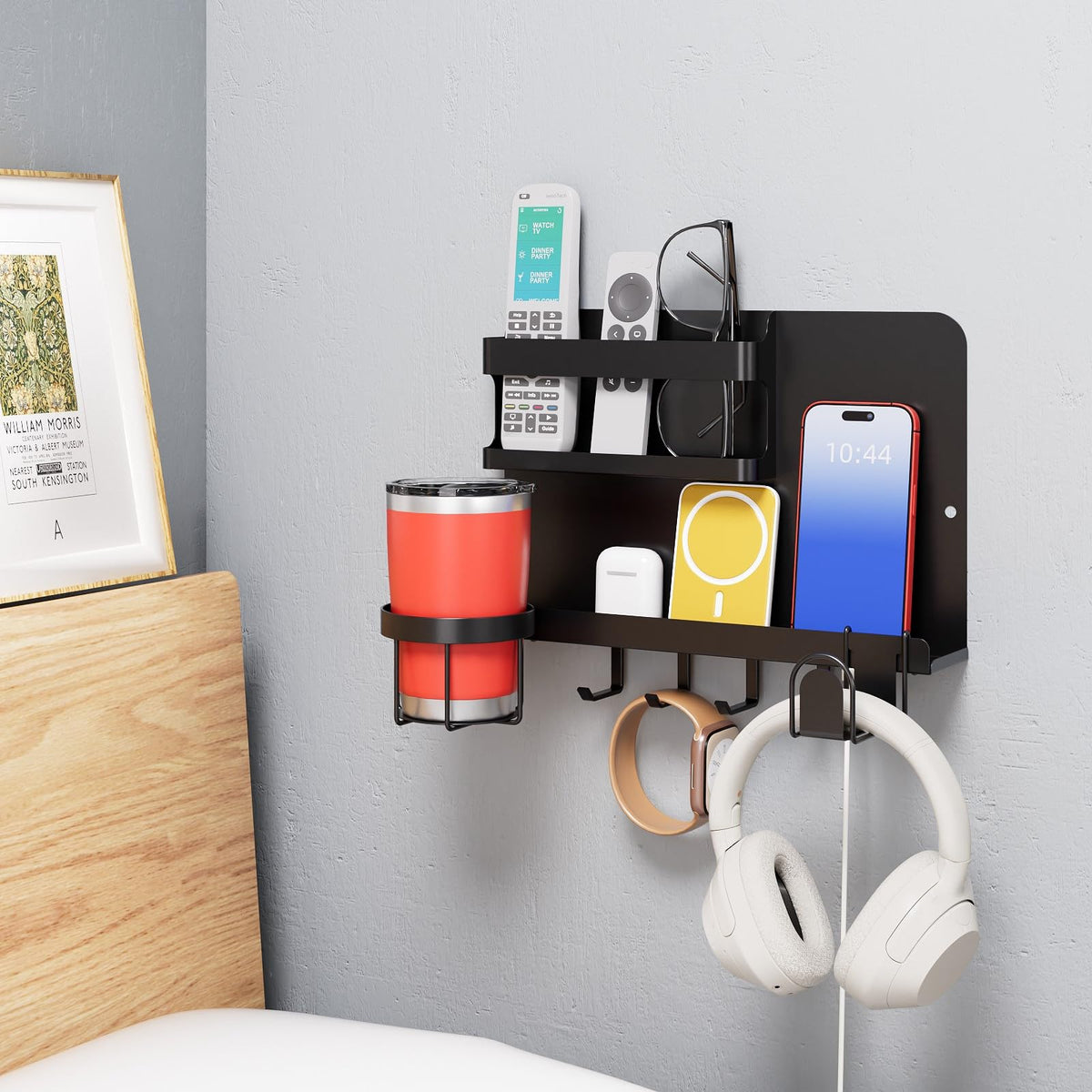 KMUZAWN bedside wall organizer keeps phone and remotes within easy reach.
