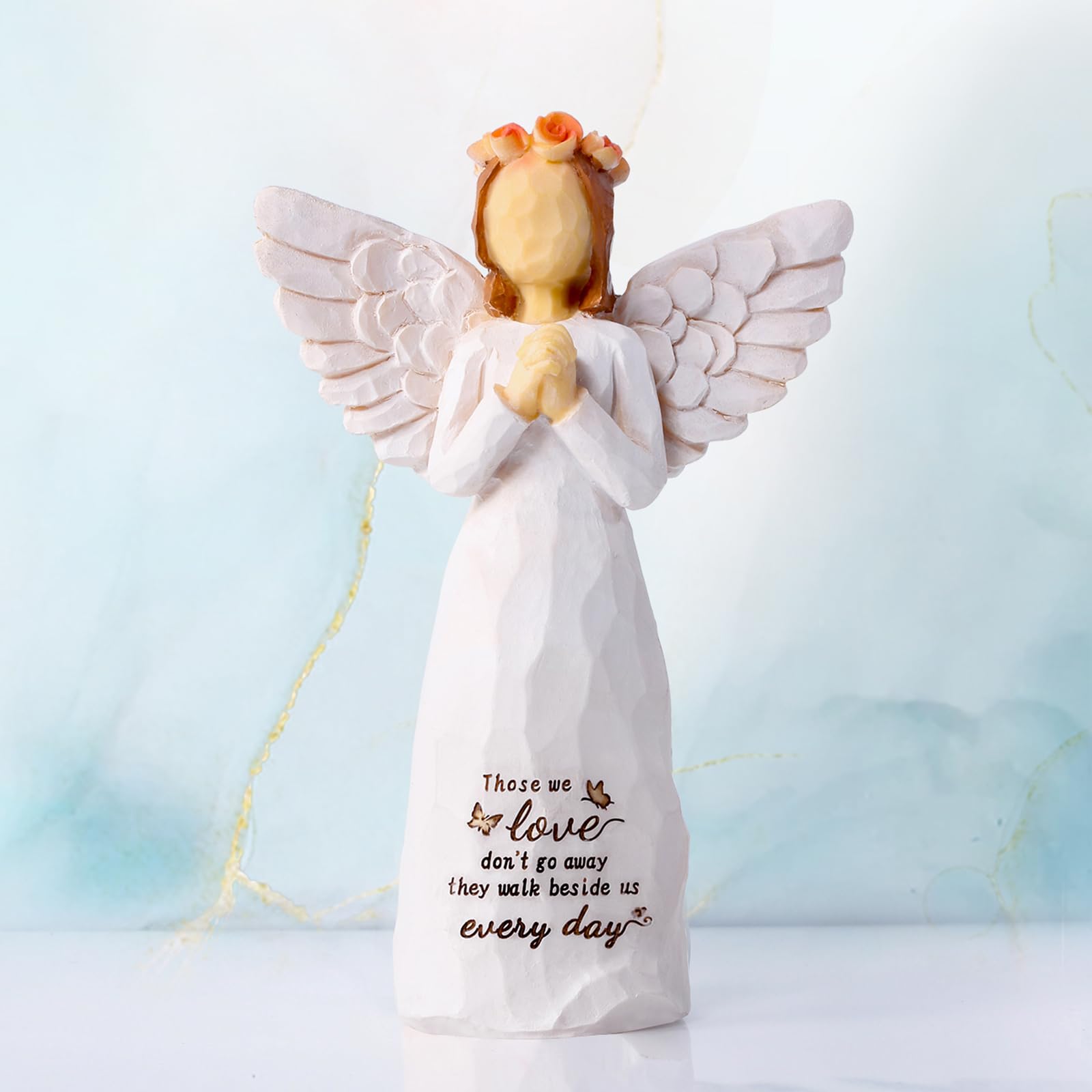 Closeup of praying hands detail on Kohehe angel, a serene remembrance gift.