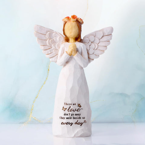 Closeup of praying hands detail on Kohehe angel, a serene remembrance gift.
