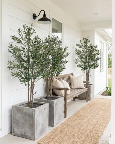 KOL artificial olive tree full silhouette adds natural charm to entryways.