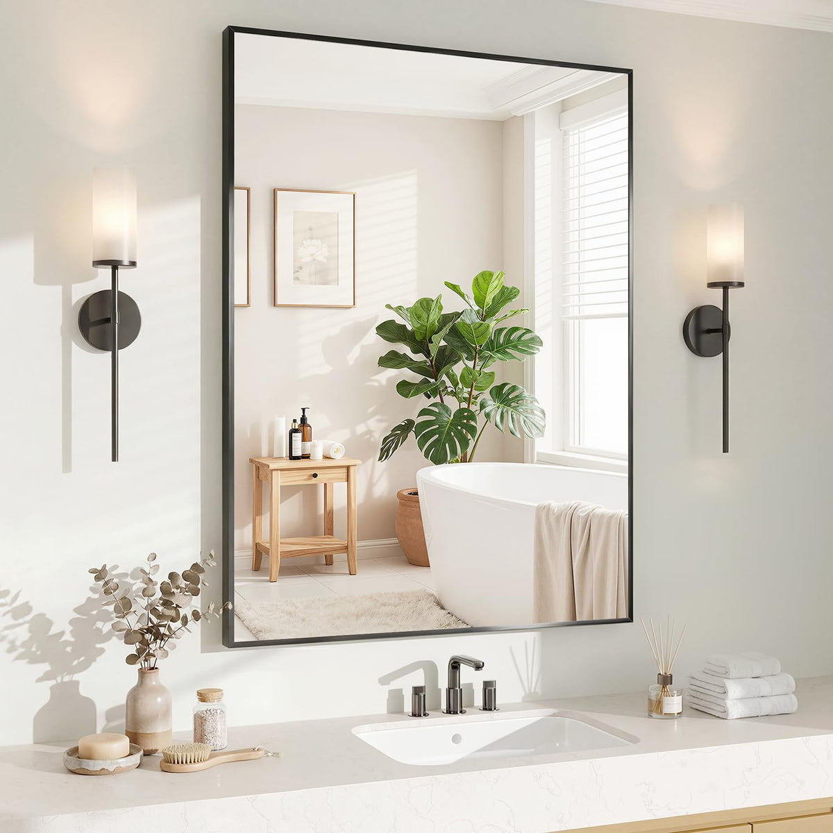 Koonmi black 24x36 inch mirror mounted horizontally above a bathroom vanity