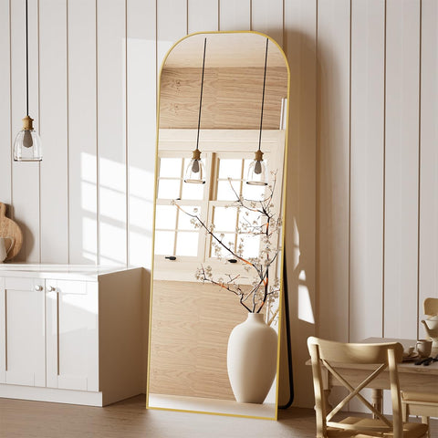 Koonmi full-length mirror with gold domed top enhances room style and full-body visibility.