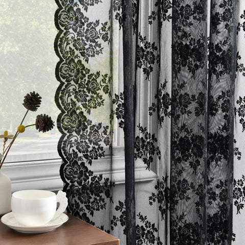 Kotile black lace curtains pair hanging on a rod, offering soft light and added privacy.