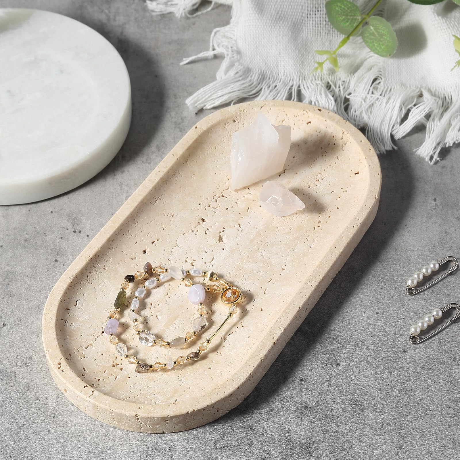 Koville travertine tray keeping remote and keys organized and accessible.