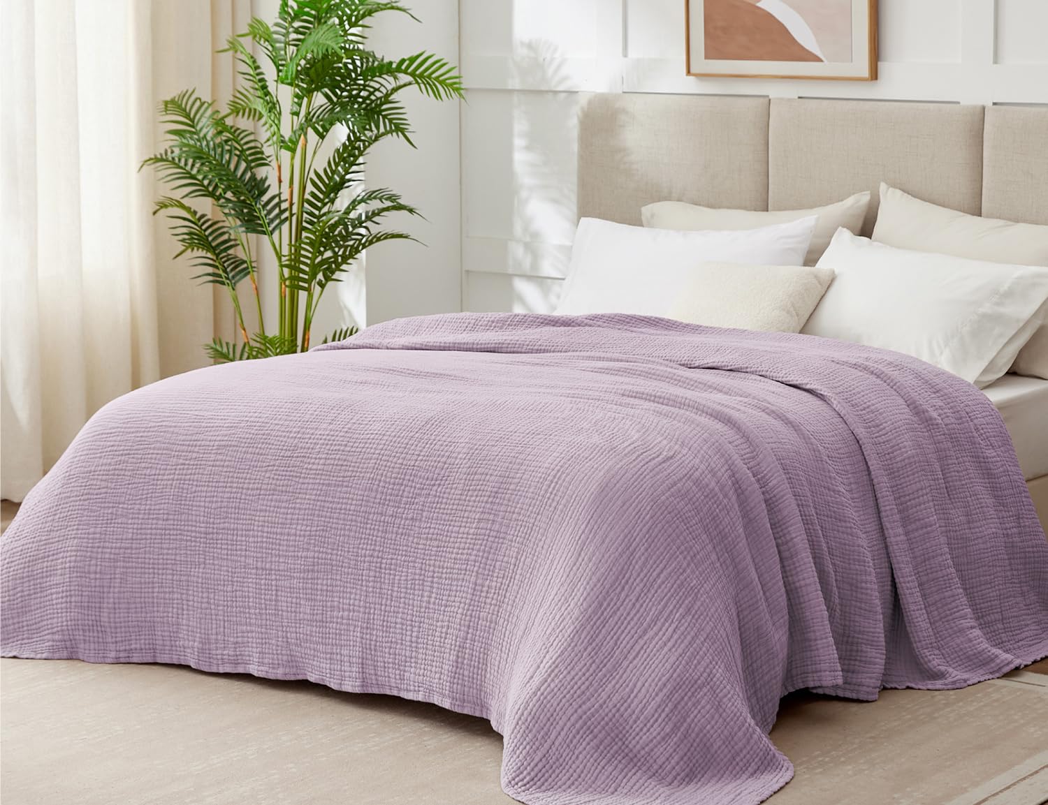 Kozyhvn lavender muslin blanket on bed highlighting breathable six layer design.