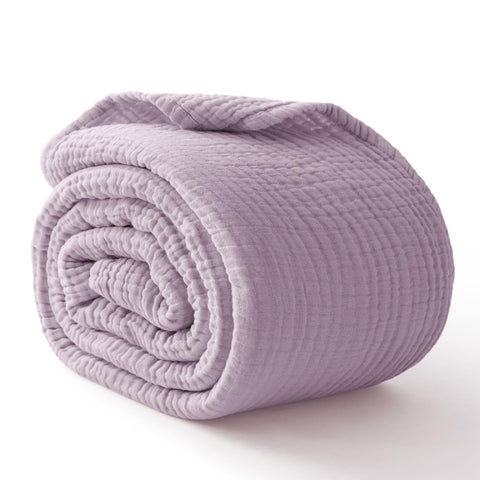 Kozyhvn queen size blanket draped on a neat bed for coverage.