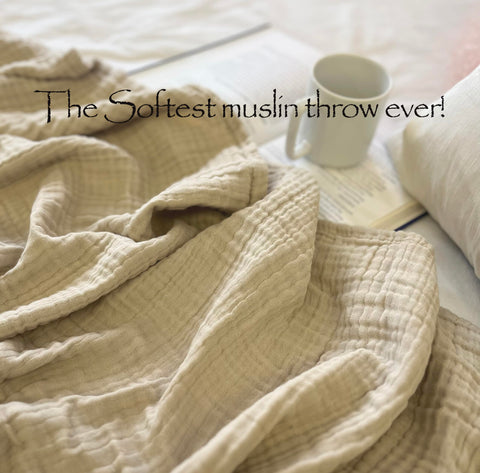 Living room setup with KyraHome muslin blanket draped over sofa.