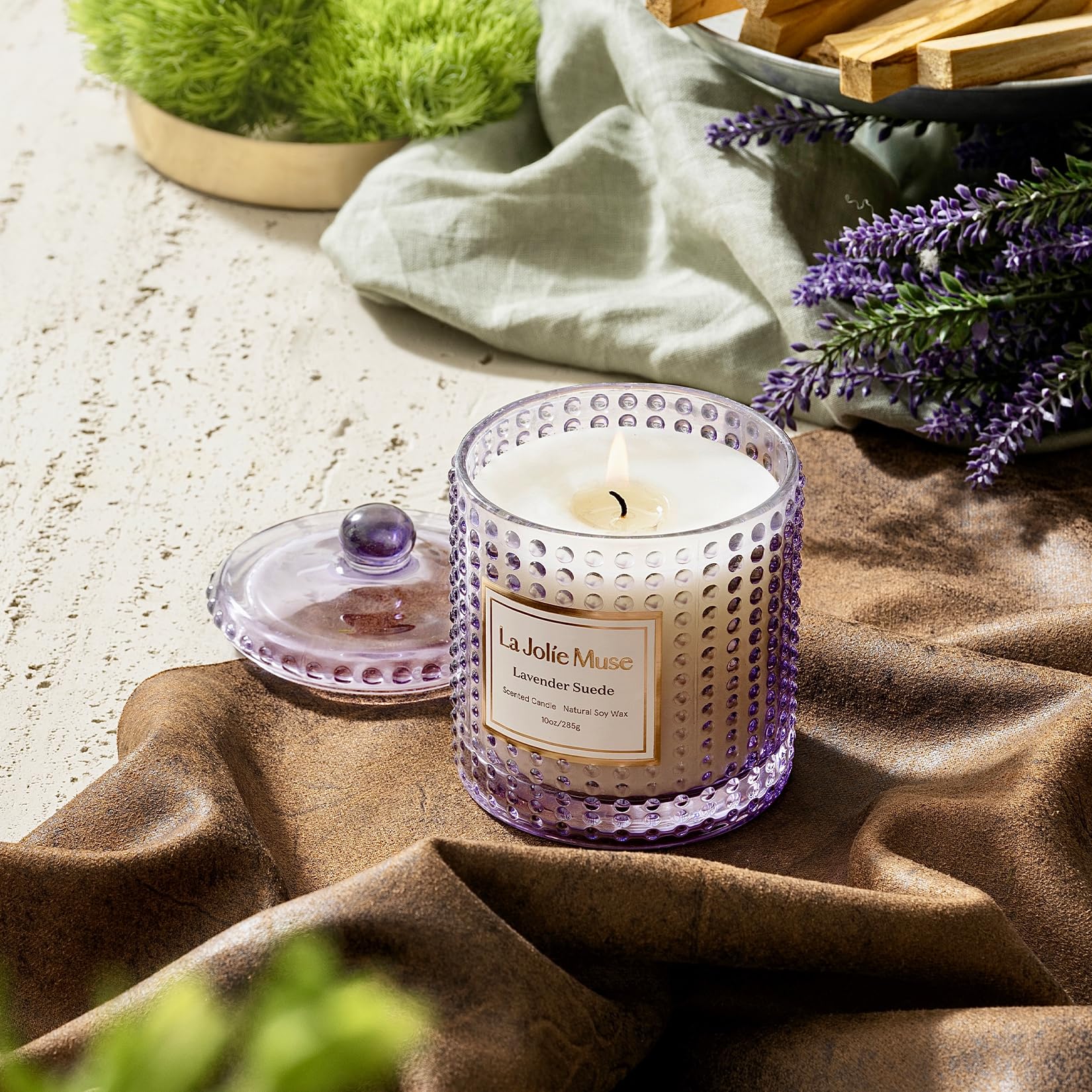 LA JOLIE MUSE hobnail glass jar enhances room decor with warm glow.