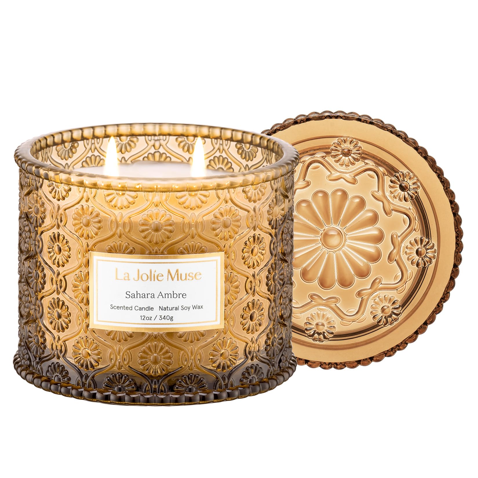 LA JOLIE MUSE Sahara Amber Candle in embossed daisy jar adds elegant decor and scent.