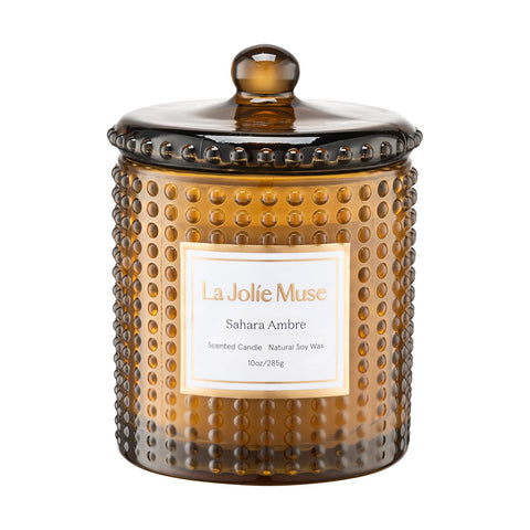 LA JOLIE MUSE Sahara Amber Candle in hobnail jar creates a warm ambiance for cozy evenings.