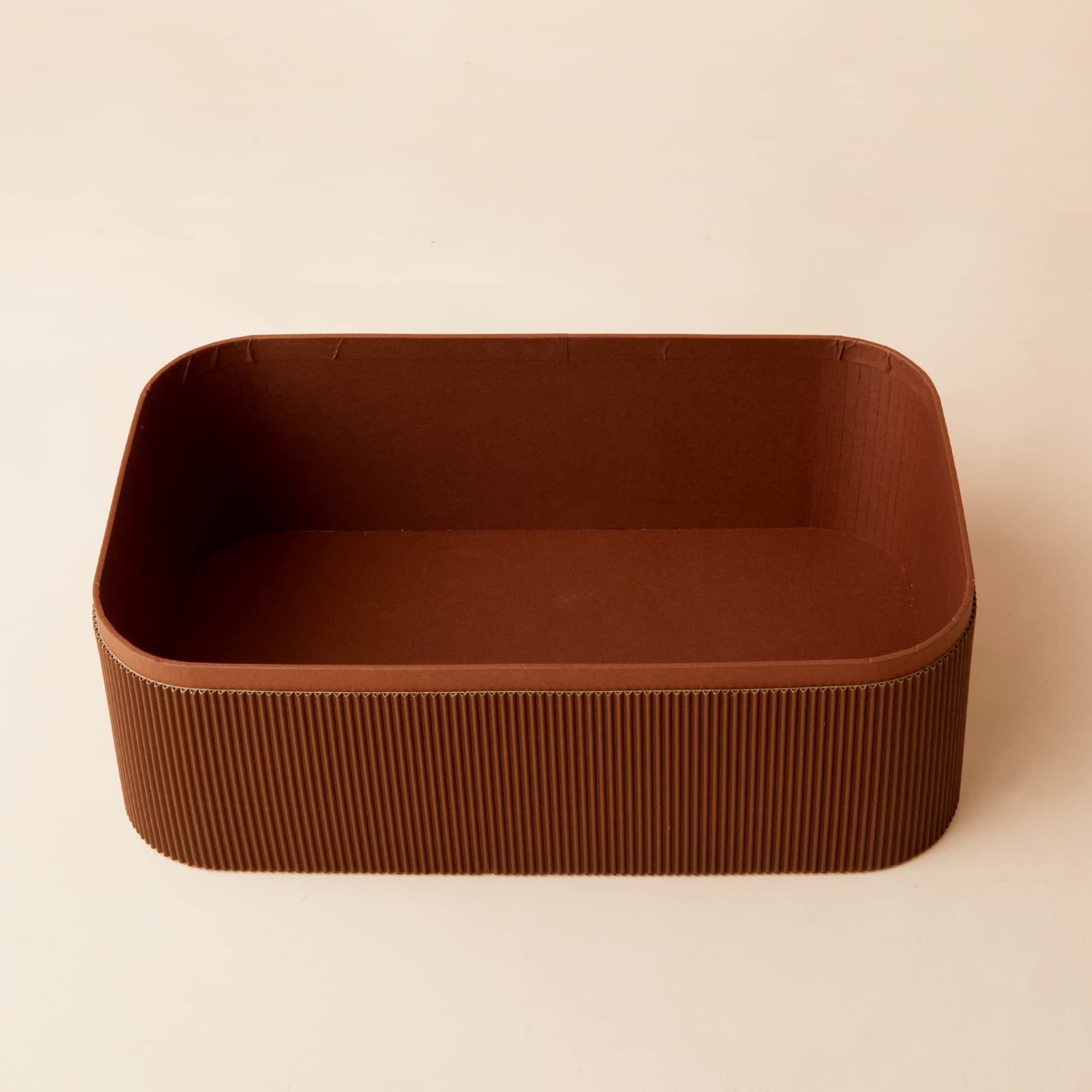 La Jolie Muse stackable baskets set organized on a shelf.