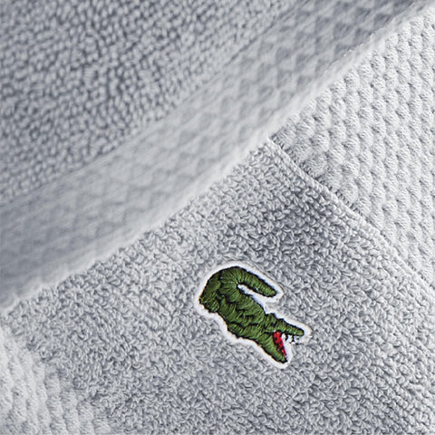 Lacoste Heritage towel close-up of border detail and pique