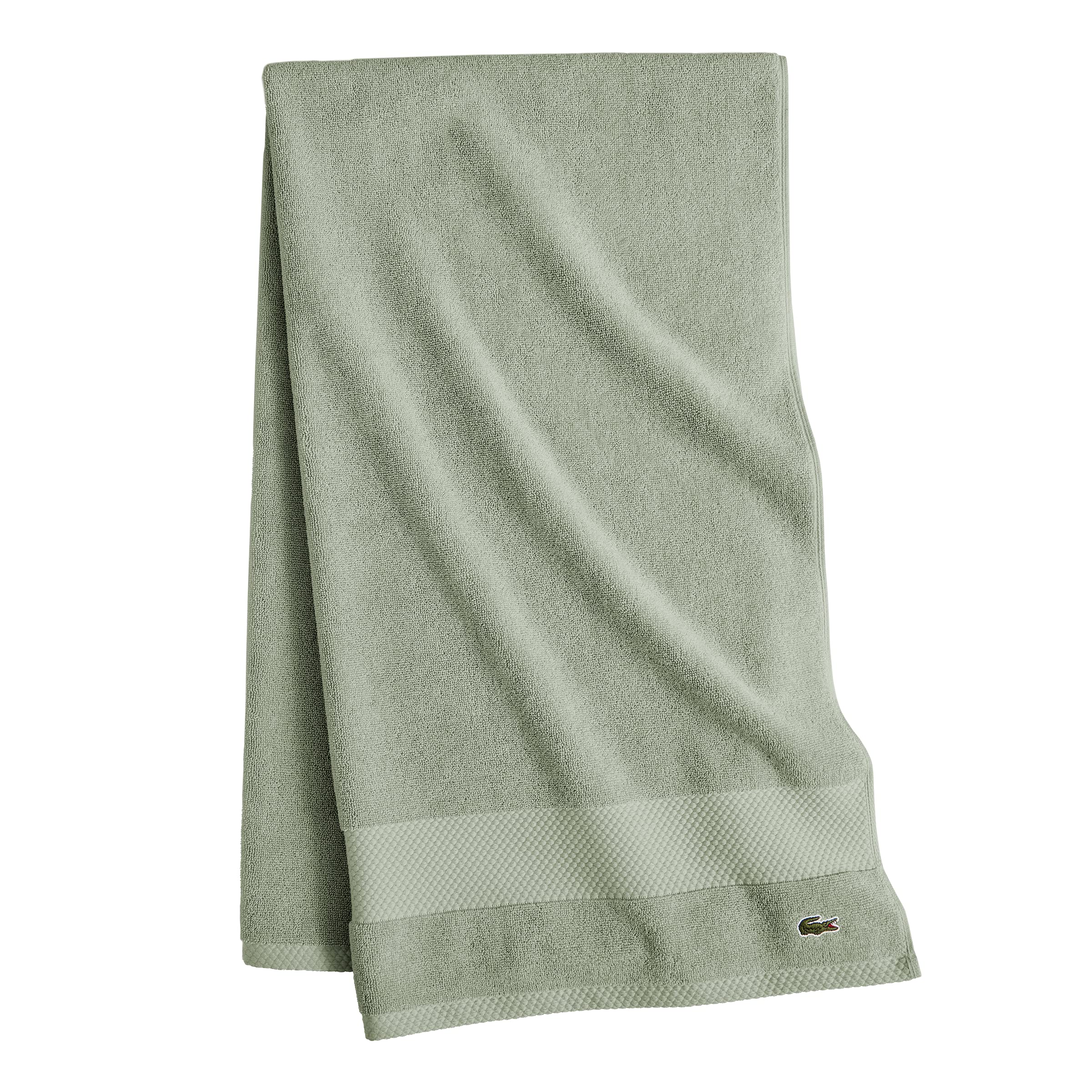 Lacoste Heritage Aloe towel in a bathroom scene suggests spa-worthy softness