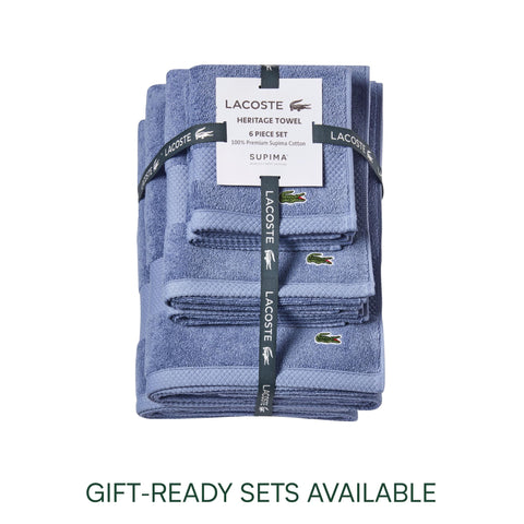 Lacoste Heritage towel folded neatly for display in a modern bathroom.
