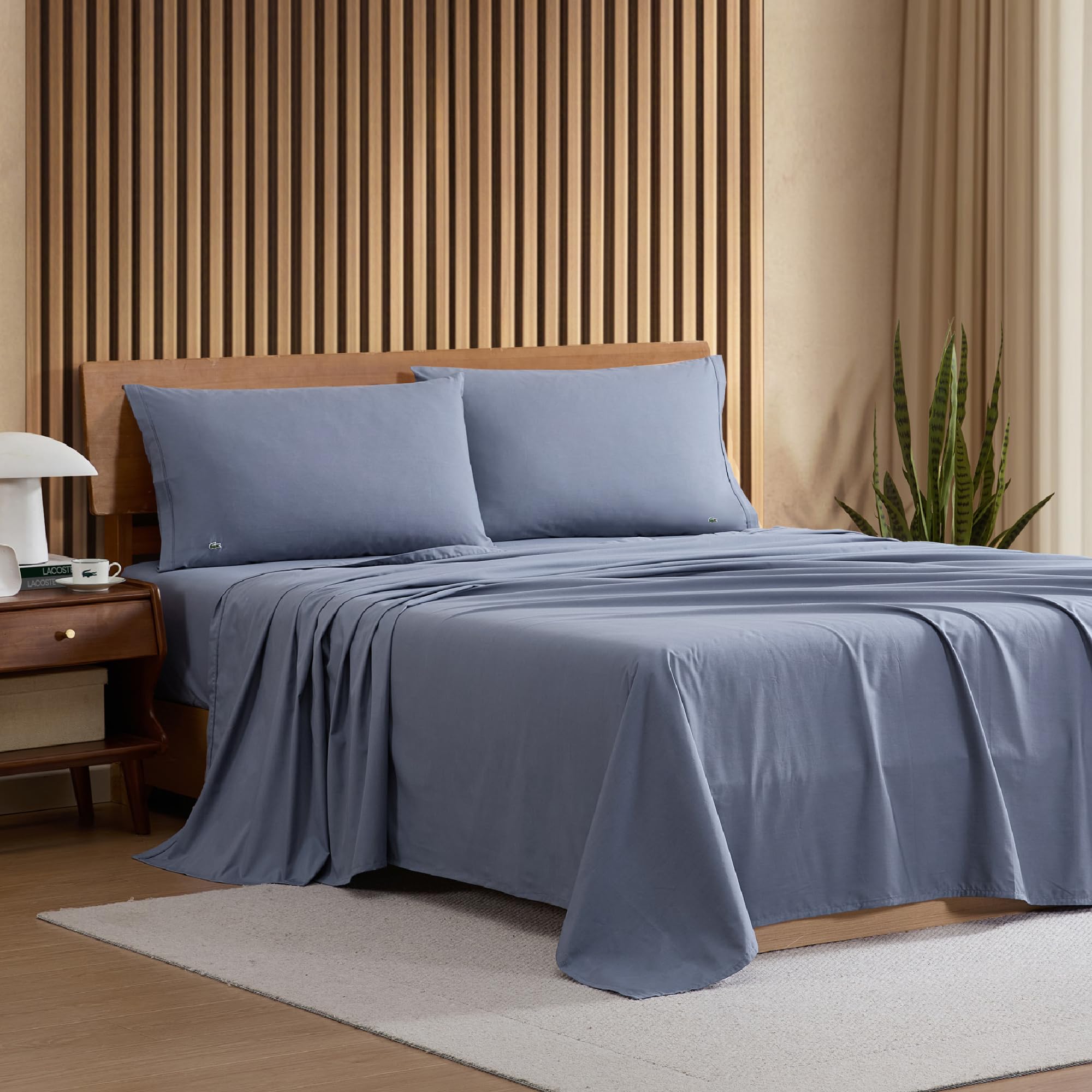 Lacoste indigo pillowcase from the sheet set adds soft, color-coordinated pillow comfort