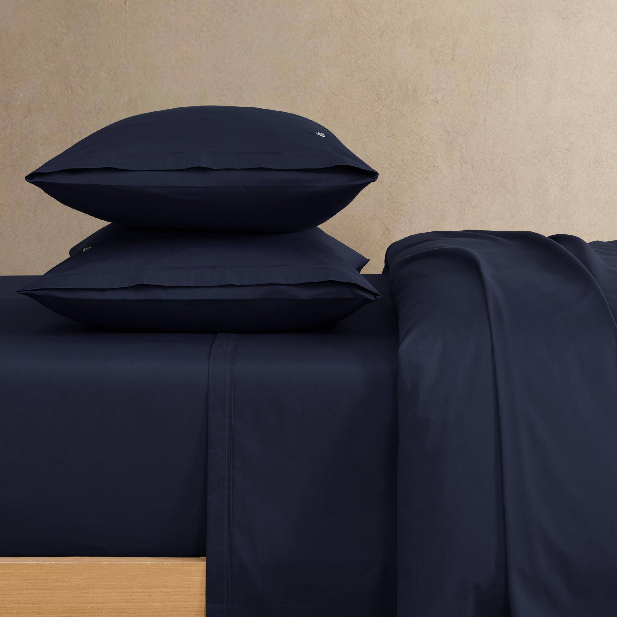 Lacoste navy fitted sheet provides a smooth surface and secure fit