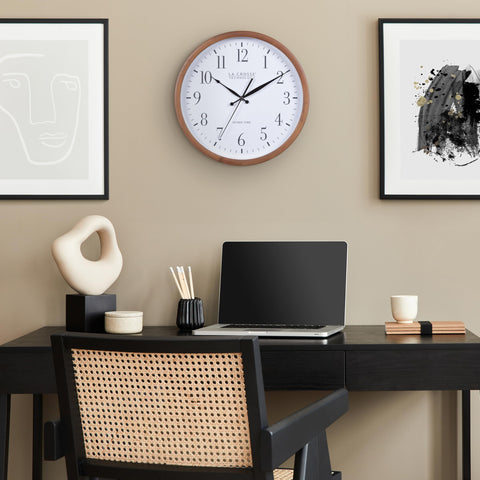 La Crosse Technology atomic analog wall clock in a cozy office setup.