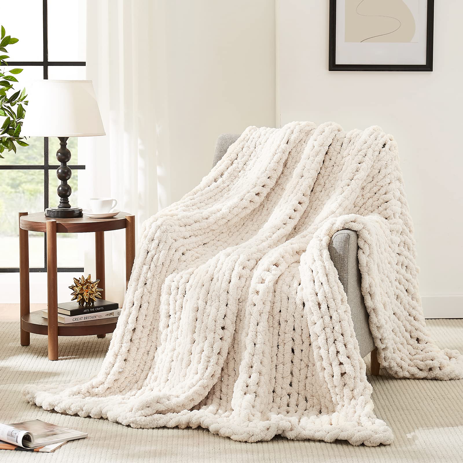 L'AGRATY ivory chunky knit blanket on a couch for cozy warmth.