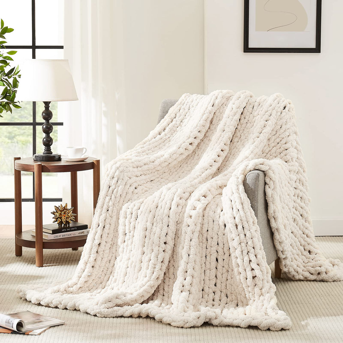 L'AGRATY ivory chunky knit blanket on a couch for cozy warmth.