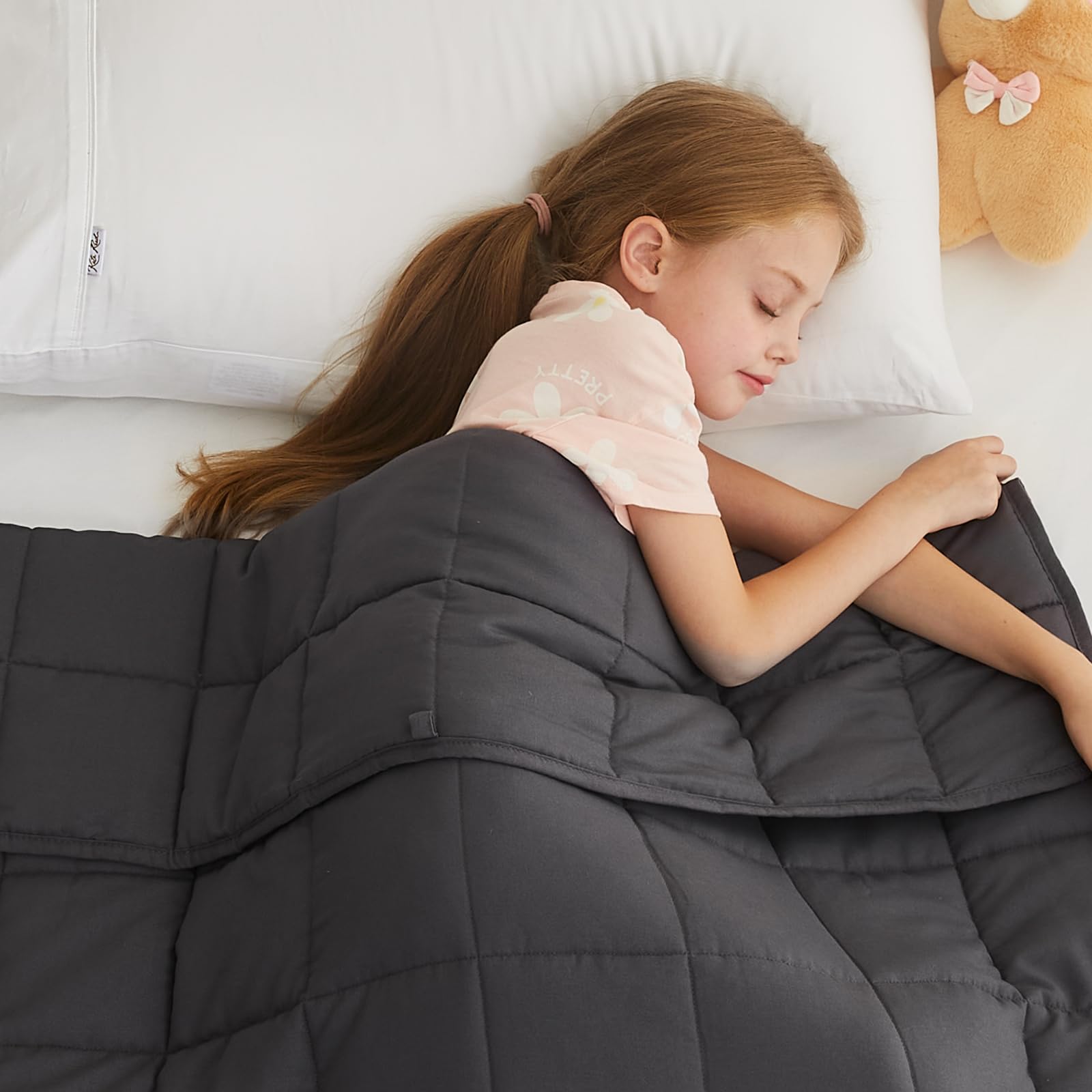 L'AGRATY Kids Weighted Blanket on a cozy bed for calm nights.