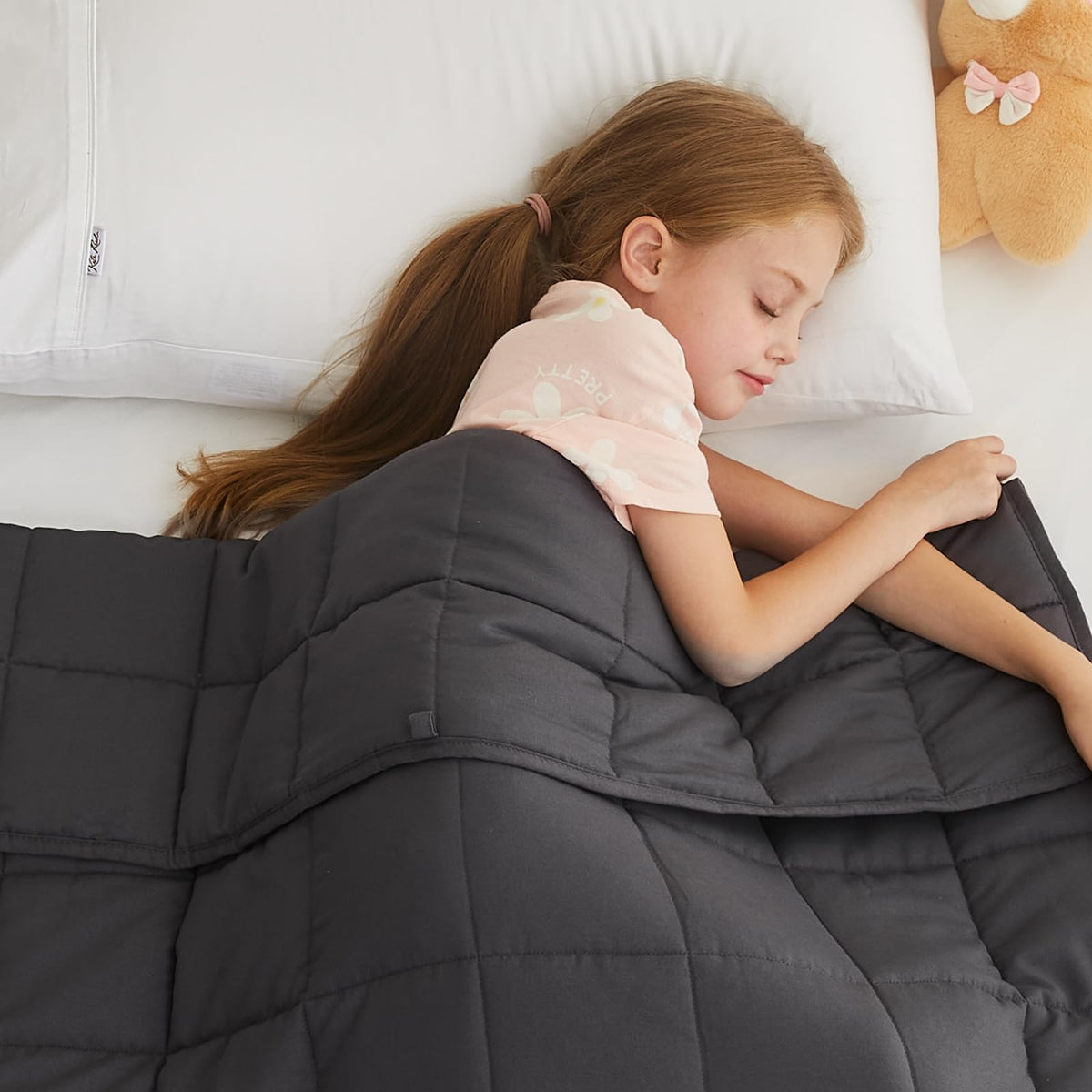 L'AGRATY Kids Weighted Blanket on a cozy bed for calm nights.