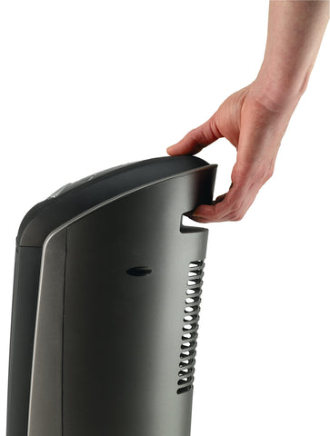 Lasko 1500W ceramic tower heater in a living room setup for family warmth