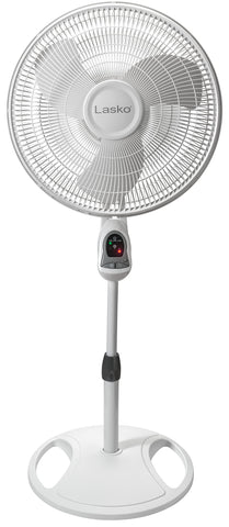 Lasko pedestal fan in a bedroom setup for cooling.